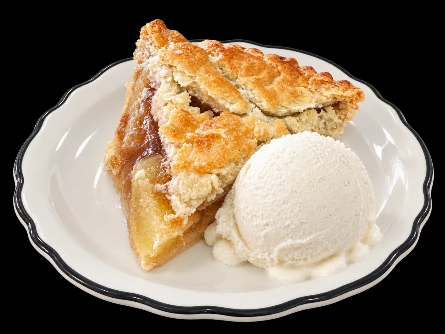 A slice of apple pie with a scoop of vanilla ice cream on a black-rimmed dessert plate
