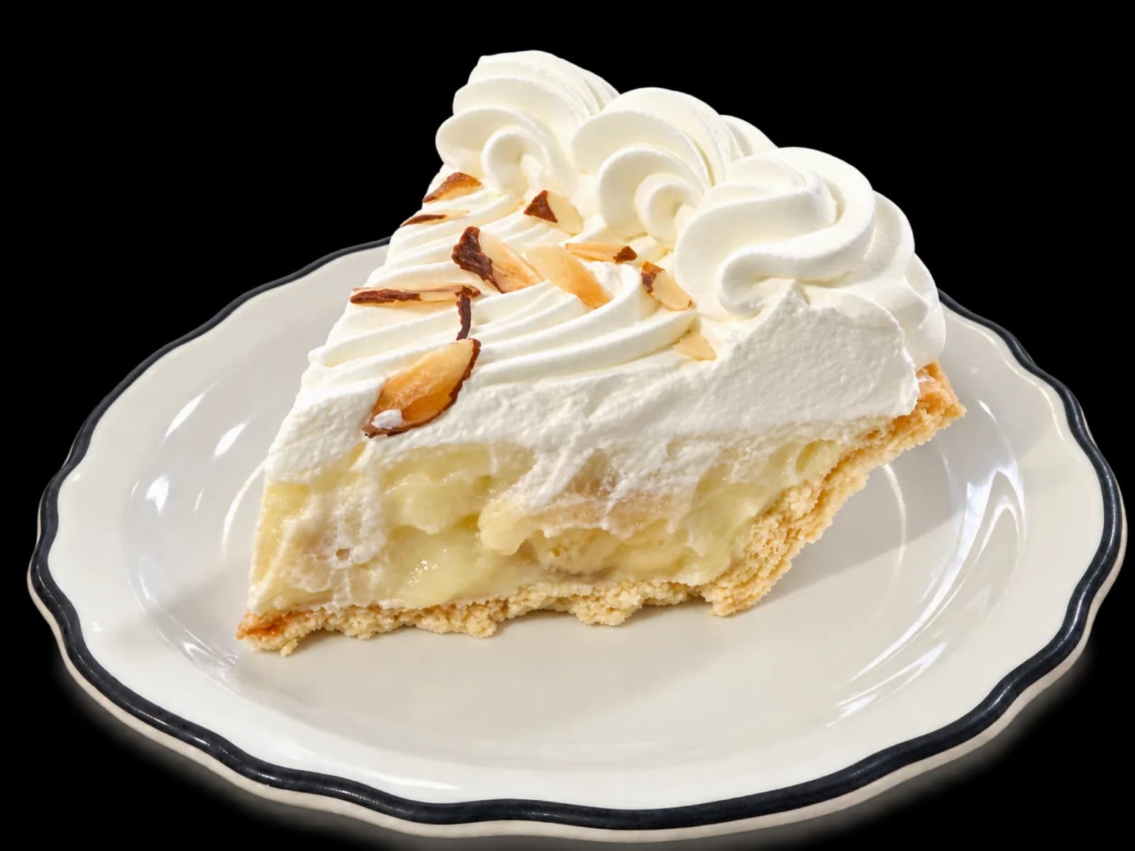A slice of banana cream pie on a black-rimmed dessert plate