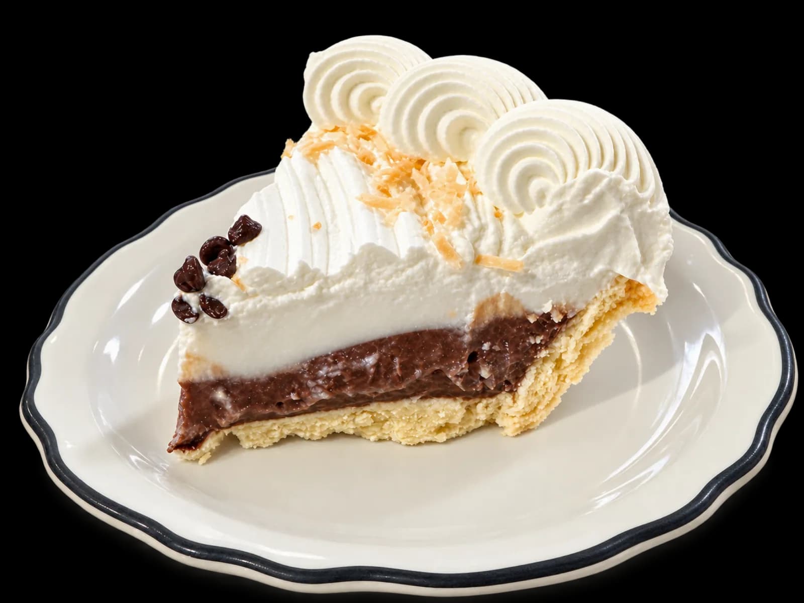 A slice of haupia chocolate pie on a black-rimmed dessert plate