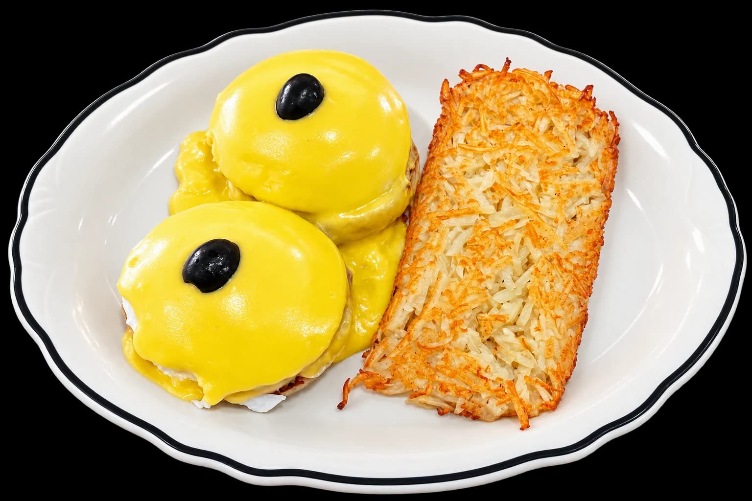 Eggs Benedict with Canadian bacon, hollandaise and hash browns